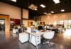 Noisy and stuffy offices linked to lost productivity and retention concerns A spacious and modern open-plan office with natural lighting and employees working at desks.