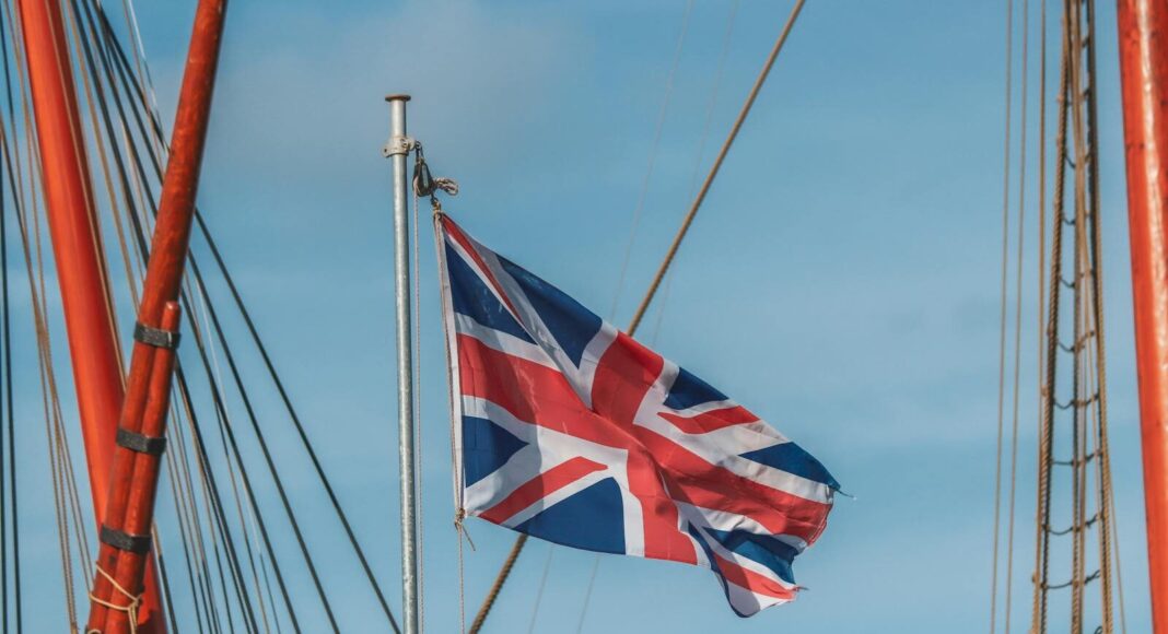 Union Jack flag waving prominently from a ship mast, capturing a sense of patriotism.