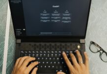 Workers ‘ignore AI tools and stick with manual tasks’ despite heavy investment Hands typing on a laptop with ChatGPT open.