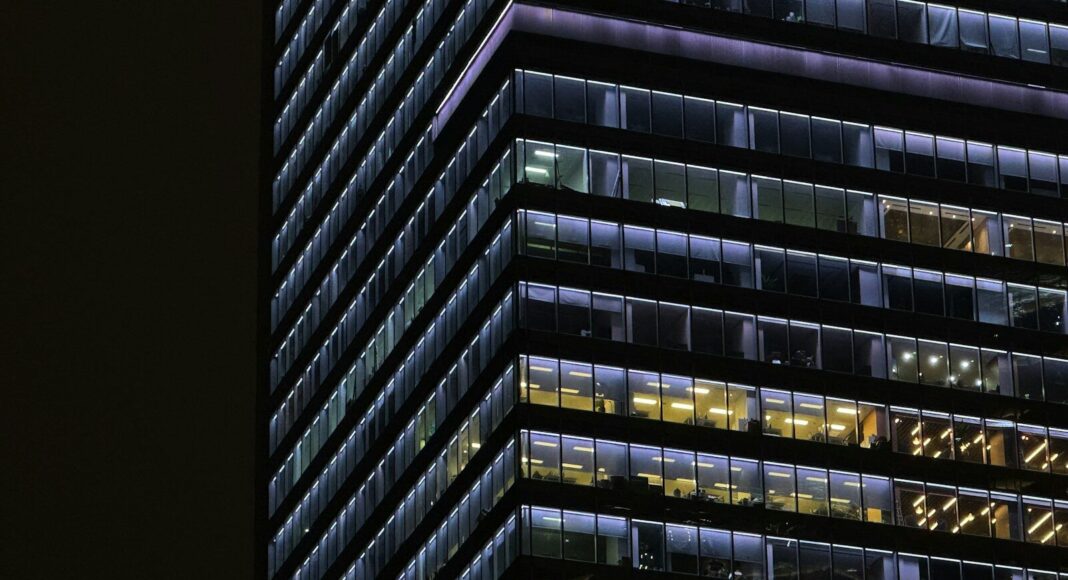 An office building with lights still on.