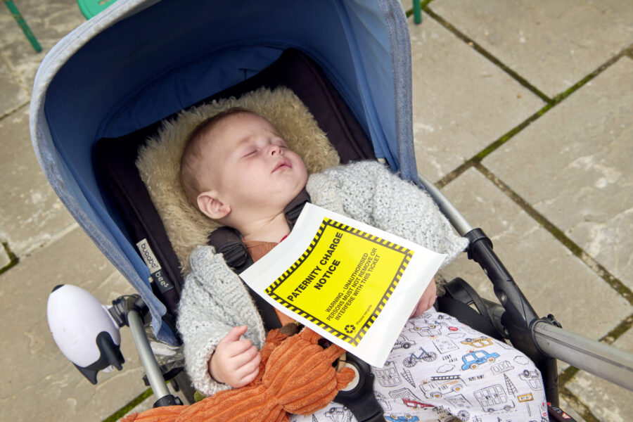 A baby sleeps in a pram.