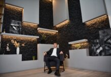 Return-to-office mandates linked to narcissistic leaders, researchers claim A businessman in a suit sitting confidently in a modern office setting.