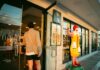 Employers urged to act as McDonald’s launches 2,500 paid work placements A man in casual attire enters a McDonald's restaurant, past a Ronald McDonald statue, during daylight.