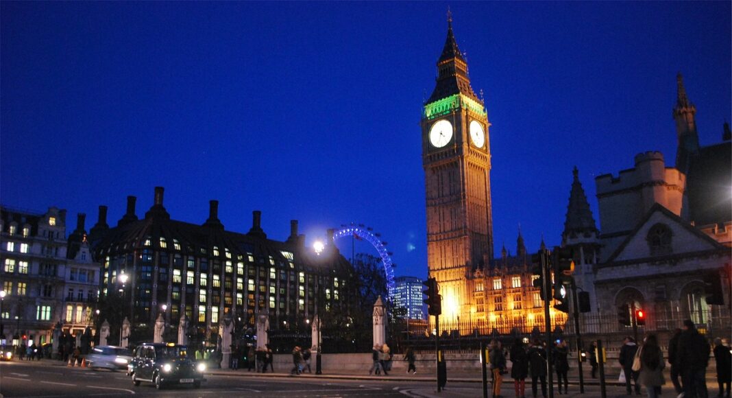 UK Parliament buildings at night.