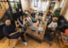 AI at Work: AI is creating a two-tier workforce. Here’s how to navigate it A group of diverse professionals collaborating in a modern office setting with laptops and technology.