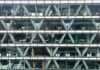 Employers plan smaller pay rises for 2027 despite inflation uncertainty Office building facade with glass windows.