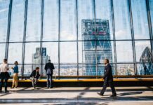 Workplace silence leaving staff afraid to raise mistakes People walk in a London high-rise office.