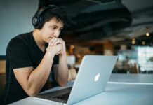 Skills overhaul needed as 40% of job capabilities set to change by 2030 A man wearing headphones while sitting on a chair in front of a laptop