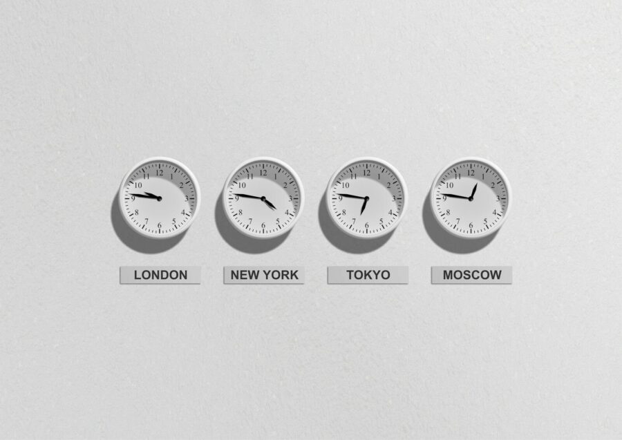 Four wall clocks showing time zones for London, New York, Tokyo and Moscow.