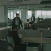 People working in an darkened open-plan office.