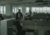 Public fears AI job losses as entry-level roles come under pressure People working in an darkened open-plan office.