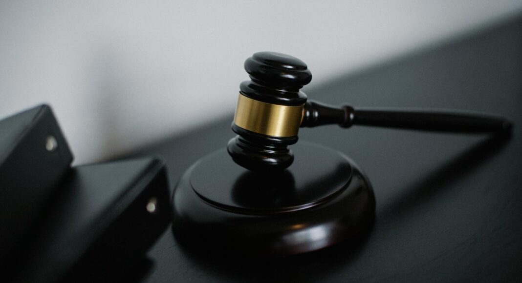 Close-up of a wooden gavel on a desk, symbolizing justice and legal authority.