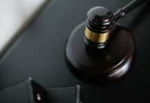 Worker fired over toilet vape row wins £22,000 unfair dismissal payout Close-up of a wooden judge's gavel on a black desk, symbolising justice and law.