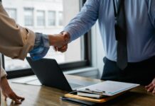 HR hiring rises as firms respond to compliance pressure and employment law changes Two people shake hands after a job interview lead to an employment offer.
