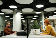 UK towns exposed as gender pay gaps exceed 25% in worst-hit areas A man and woman sit opposite each other in an office.