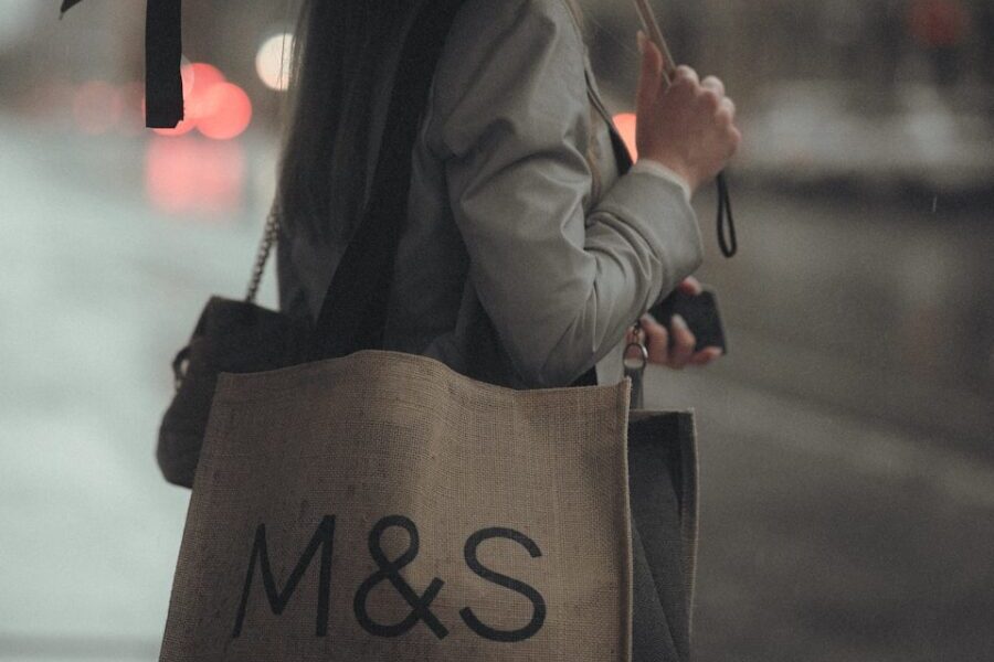 person in black coat holding umbrella