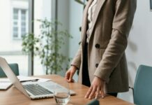 Revealed: Women sell themselves £9,000 short before they even apply for jobs A professional businesswoman in a stylish office environment with a laptop and notes.