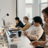Young professionals working collaboratively in a modern office environment, fostering teamwork and innovation.