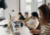 Young workers quitting jobs because they feel unable to speak up, employers warned Young professionals working collaboratively in a modern office environment, fostering teamwork and innovation.