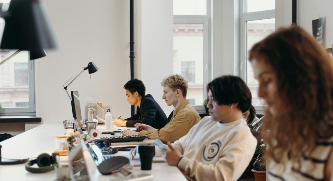 Young professionals working collaboratively in a modern office environment, fostering teamwork and innovation.