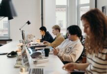 Young workers quitting jobs because they feel unable to speak up, employers warned Young professionals working collaboratively in a modern office environment, fostering teamwork and innovation.