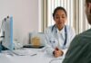 GPs say it’s ‘not worth the grief’ to refuse mental health sick notes A female doctor consulting a patient in a modern medical office setting.