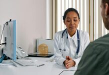 GPs say it’s ‘not worth the grief’ to refuse mental health sick notes A female doctor consulting a patient in a modern medical office setting.