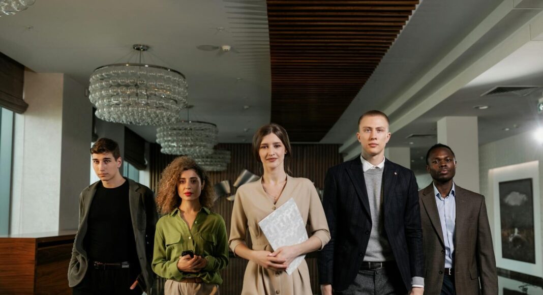 A diverse group of professionals confidently walking through a stylish office environment.