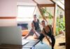 Workplace workouts: simple ways to move more at your desk and boost health and productivity A man and woman working out at home using a laptop for guided exercises. Indoor active lifestyle.