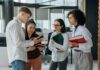 Youth unemployment set to hit 17.8 percent, business group warns Four young colleagues engage in a collaborative discussion in a modern office setting.