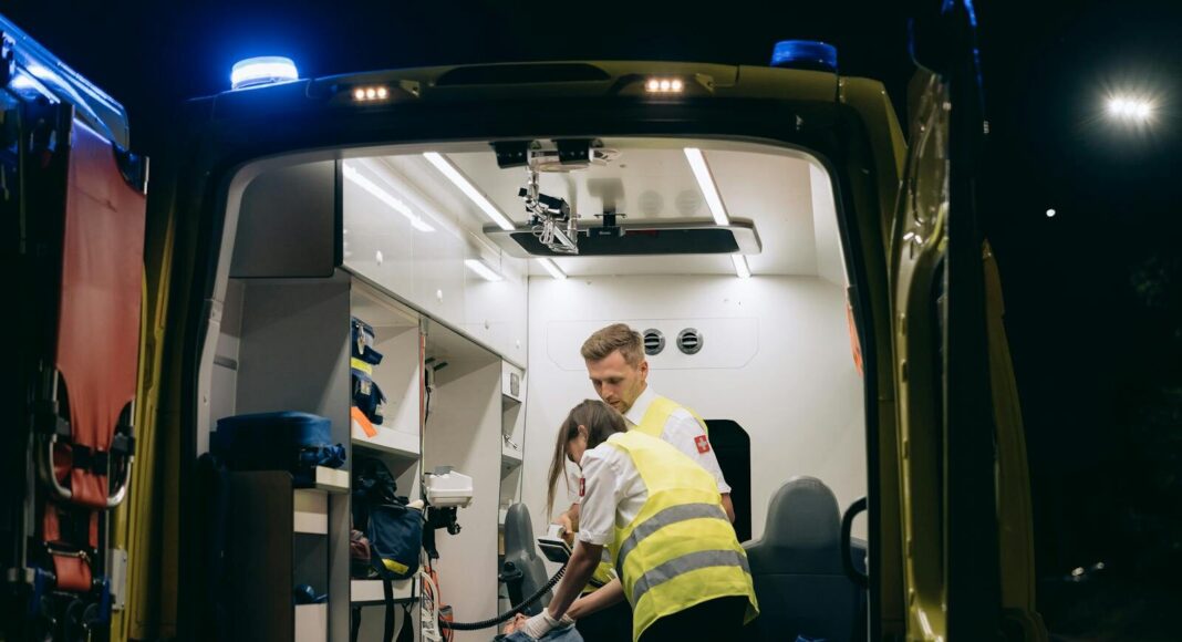 Photo by Mikhail Nilov Paramedics attend to a patient inside an ambulance, providing emergency medical assistance at night.