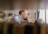 UK’s always-on work culture ‘driving employee burnout’ A person appears stressed while working at a computer.