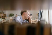UK’s always-on work culture ‘driving employee burnout’ A person appears stressed while working at a computer.