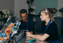 Managers lose funding as £3,000 grants drive youth hiring push Young engineers working on a robot project in a workshop setting.