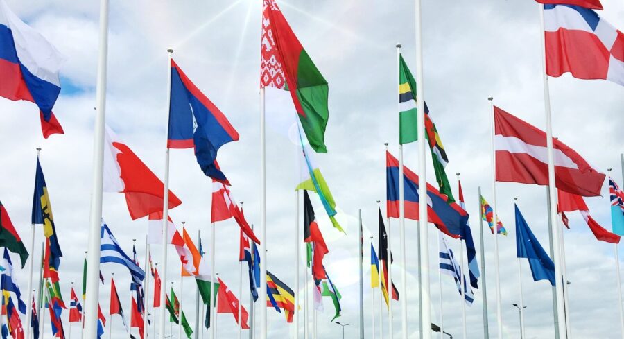 Flags of countries fly on poles.