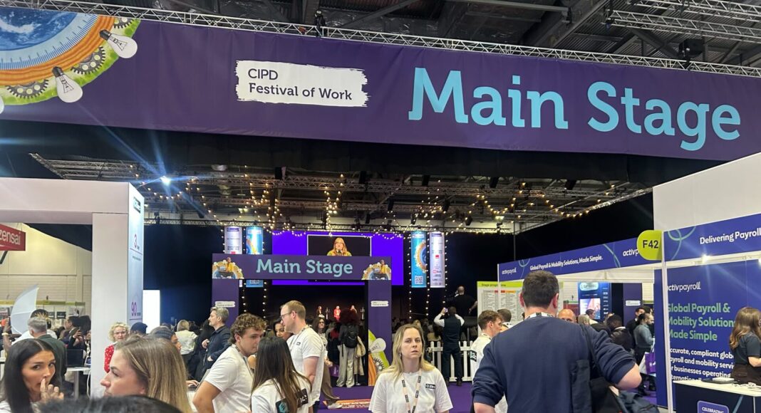 CIPD-Festival of Work People walk around in front of the Main Stage area of the CIPD Festival of Work.