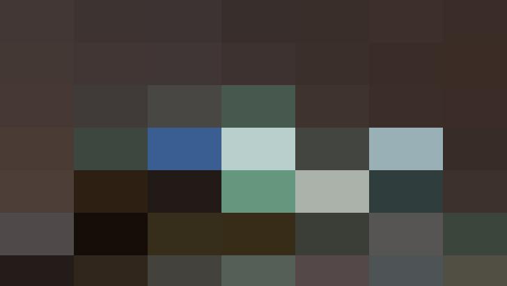 A nighttime view of a city's skyline featuring several illuminated skyscrapers and office buildings, where the reflections in the water could almost symbolize the cohesive structure of effective people management.