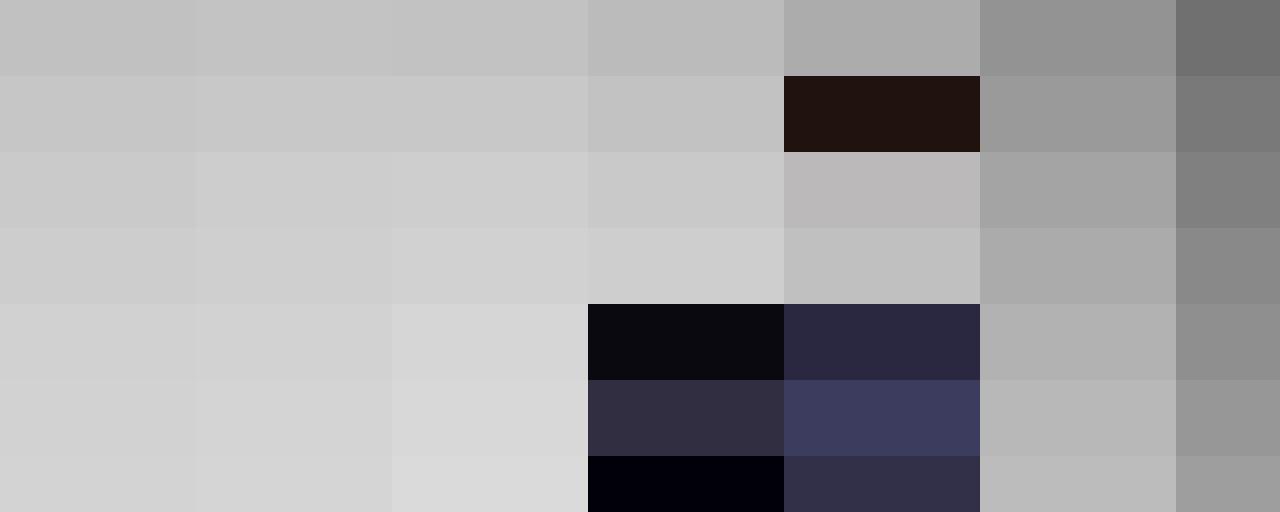 A man with short hair wearing a dark blazer over a dark sweater and white shirt stands against a plain gray background. He looks slightly to the side, embodying the professional demeanor often associated with Human Resources specialists.