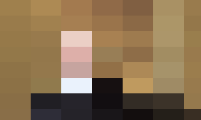 Middle-aged Caucasian man with greying hair, wearing a navy sweater and white shirt, speaking about people management in a room with beige walls.