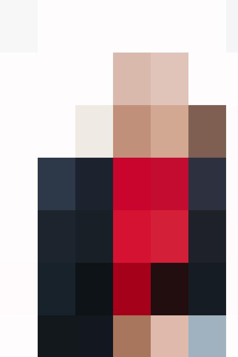 A woman in a blazer and red dress is posing for a photo.