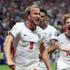 Harry Kane of England celebrates with teammates Jude Bellingham and Anthony Gordon after scoring his team's first goal during the FIFA World Cup 2026 Round of 32 match between England and Congo DR at Atlanta Stadium on July 1.