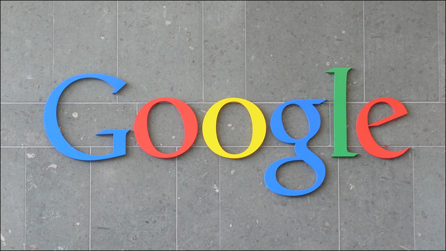 The Google logo in colorful letters is displayed on a gray tiled wall, reflecting the company's innovative approach to People Management.