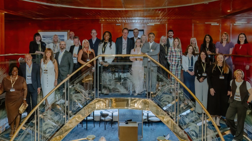 HR leaders recognised by the CIPD stand on a stairwell for a group photograph.