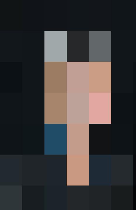 A personnel with gray hair smiling for the camera.