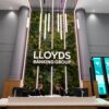 A reception area at a Lloyds Banking Group office with two staff behind the desk.