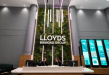Lloyds plans 1,000 AI roles as debate over jobs impact continues A reception area at a Lloyds Banking Group office with two staff behind the desk.