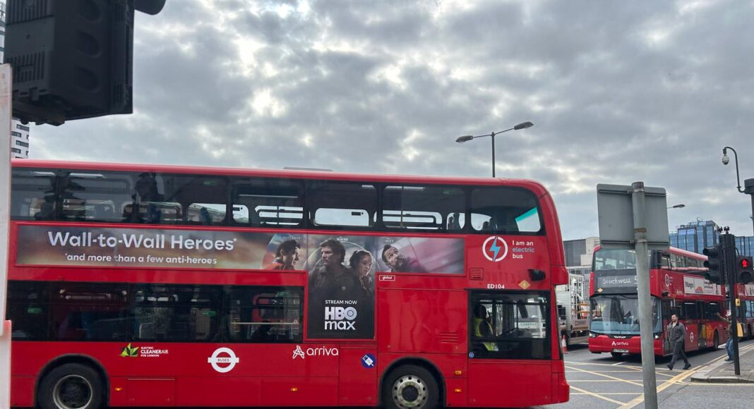 Two London buses on a street.