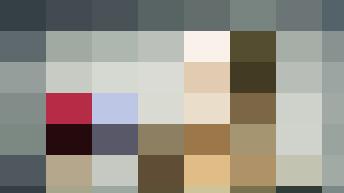 A woman from the HR department holding a stack of euro banknotes tied with a red ribbon, smiling at the camera against a textured gray background.