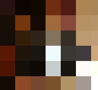 A man in a suit sitting at a desk, managing people in an HR role.