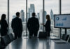 Employers prioritise cost control over growth as confidence remains weak, CIPD says Businesspeople look out of an office window.